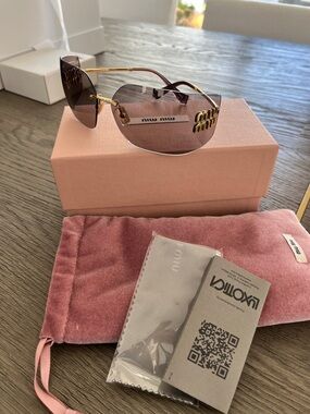 Miu Miu Black Sunglasses with Gold Accents